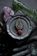 Brass pendant with ceramic cabochons